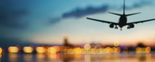Plane landing on runway at dusk.